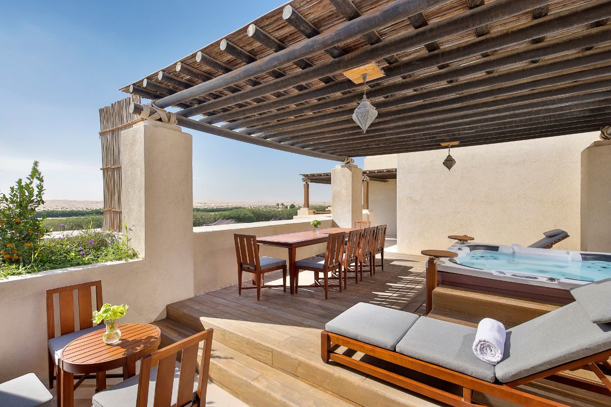 Outside view in a villa with jacuzzi, dining sets and pool chairs overlooking the view at Al Wathba, a Luxury Collection Desert Resort & Spa for a staycation in the UAE
