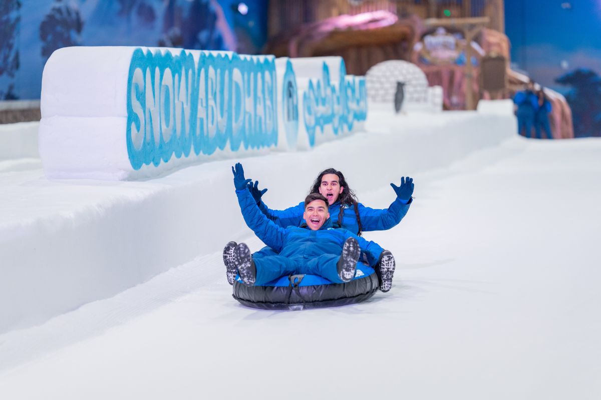 Snow Abu Dhabi 2 guys enjoying the snow slides indoor things to do at Snow Abu Dhabi
