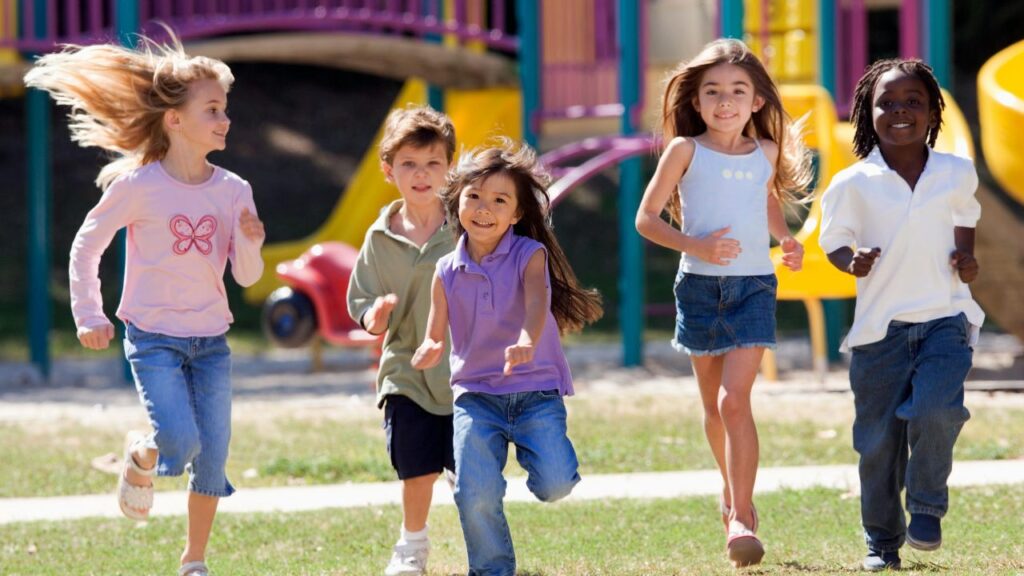 spring camps kids running at park or greenery