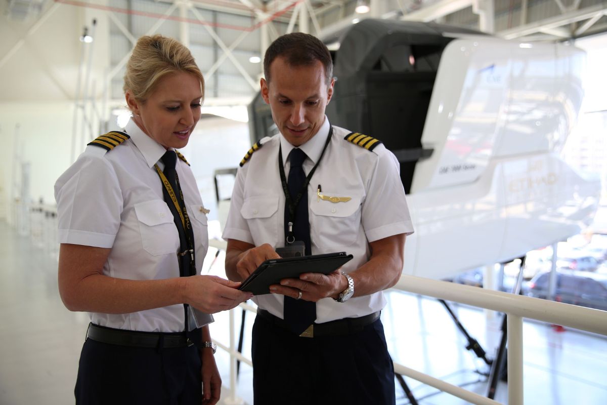2 pilots at Etihad Airways looking through a tablet