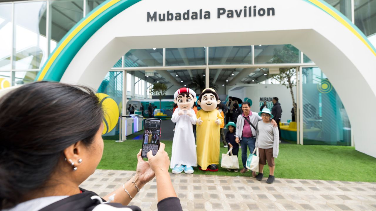 Fans pictured with the Mubadala mascosts at the Mubadala Pavilion